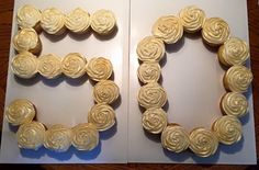 an open book with two cupcakes in the shape of letters e and f