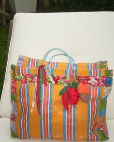 an orange striped bag sitting on top of a white chair