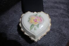 two heart shaped dishes with flowers painted on them