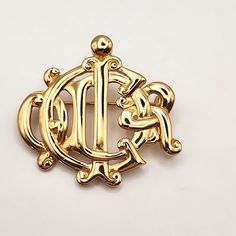 Vintage Christian Dior Monogram Gold Brooch Made In Germany In Excellent Condition 1.5" X 1.5" Luxury Engraved Brooch For Anniversary, Luxury Engraved Yellow Gold Brooches, Luxury Engraved Brooches As Gift, Elegant Engraved Yellow Gold Brooches, Classic Engraved Brooches For Formal Occasions, Luxury Engraved Brooches For Formal Occasions, Classic Hallmarked Brooch For Anniversary, Classic Hallmarked Brooches For Anniversary, Classic Engraved Yellow Gold Brooch