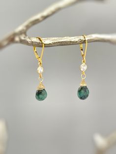 Genuine Emerald Earrings. Dainty handmade crystal dangle tear drop earrings.  Dainty raw emerald gemstone tear drops are wire wrapped in 14k gold fill or sterling silver and hang from sparkling bezel set crystals. Matching French hook or leverback earring backs available. Gemstone drops are dainty approx 8x9mm. Simple, elegant everyday earrings. Lightweight elegant earrings.  Emeralds are organic in nature and contain some color variations and inclusions. Please see photo for some examples. Emer Dainty Jewelry With May Birthstone Natural Stones, Everyday 14k Gold Filled Teardrop Jewelry, Delicate Teardrop Jewelry With Natural Stones, Dainty Green Dangle Earrings, Green Dainty Dangle Earrings, Delicate Teardrop Natural Stone Jewelry, Delicate Natural Stone Teardrop Jewelry, 14k Gold Filled Dainty Teardrop Dangle Earrings, Sterling Silver Drop Earrings For May Birthstone