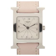 The Hermès H Stainless Leather Watch in Pink is a refined and stylish timepiece that seamlessly blends elegance with functionality. Featuring a sleek stainless steel case, the watch is adorned with a soft pink leather strap that adds a pop of color and a touch of femininity. The white dial provides a clean and crisp background, beautifully complemented by numerals index for easy readability. Powered by a precise quartz movement, the watch ensures accurate timekeeping. The iconic Hermès H at the Classic Pink Watch With Rectangular Dial, Classic Pink Watches With Rectangular Dial, Luxury Pink Watch With Rectangular Dial, Luxury Pink Watches With Rectangular Dial, Formal Pink Watch Accessories With Diamond Hour Markers, Timeless Pink Watch For Formal Occasions, Timeless Formal Pink Watch, Timeless Pink Watch Accessories For Formal Occasions, Cartier Ballon Bleu