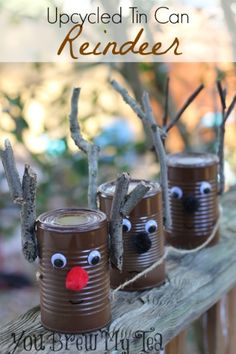 three tin can reindeers are sitting on a wooden fence with the words, upcycled