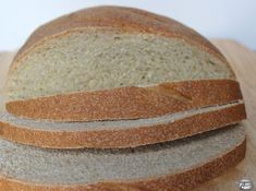 two loaves of bread sitting on top of a cutting board