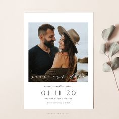 a photo save the date card with a couple in hats on it and eucalyptus leaves