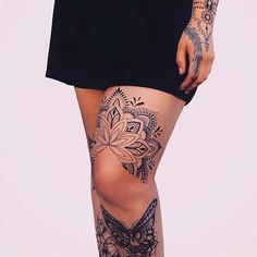 a woman with tattoos on her legs and thigh