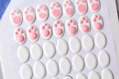 pink and white decorated cookies with paw prints on them are ready to be cut into shapes