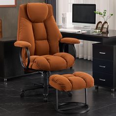 an orange reclining chair and ottoman in front of a computer desk