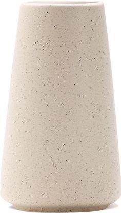 a white vase with black speckles on the top and bottom, sitting in front of a white background