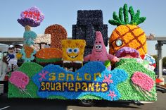 there is a float made to look like spongebob and pineapples on the street