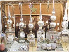 a table topped with lots of bottles filled with different types of perfumes and other items