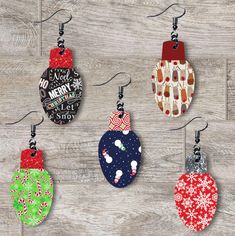 six christmas ornament ornaments hanging from hooks on a wooden surface with snowflakes