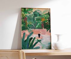 a painting hanging on the wall next to a chair and table with a potted plant