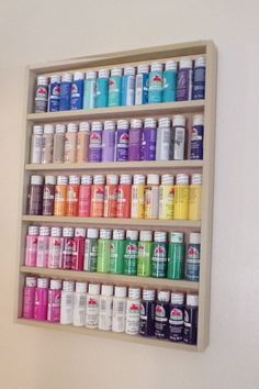 a shelf filled with lots of different types of paint