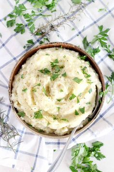 a bowl filled with mashed potatoes and garnished with parsley