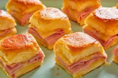 ham and cheese pastries are arranged on a green plate, ready to be eaten