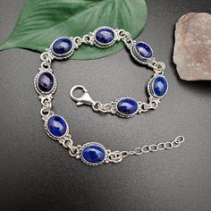 "Visit our on-line shop at: Etsy.com/shop/AlbuquerqueDesigns *sterling silver bracelet 7.25 inches long / 8 links with extension 1\" silver chain *link bracelet *southwestern jewelry *lapis lazuli *calibrated pre-cut stones: 9x7mm oval shape *back of jewelry items are all covered / do not show the back of stones *all jewelry items are made to ship, slight variations in stones will occur comparing to pictures. *size of a penny is 19mm or a dime is 18mm in diameter for comparing size with jewelry White Opal Earrings, Lapis Lazuli Bracelet, Coral Bracelet, Blue Lapis Lazuli, Coral Earrings, Opal Studs, Southwestern Jewelry, Coral Jewelry, Bracelet Boho