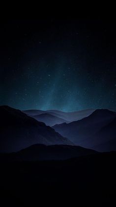 the night sky is lit up with stars above mountains and valleys in the foreground