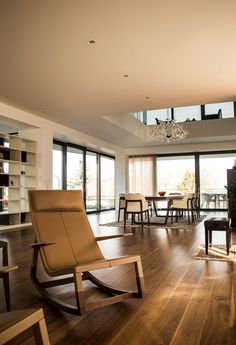 a living room filled with furniture and a fire place next to a glass wall window