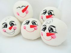 four snowballs with faces painted on them and the words snowballs in the hoop