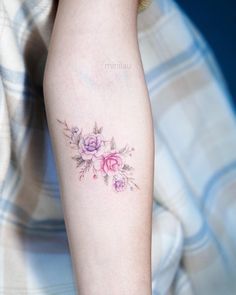 a woman's arm with pink flowers on it