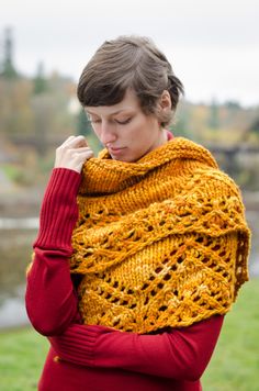 a woman wearing a yellow knitted shawl