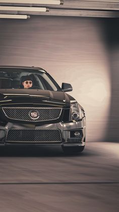 a car driving through a tunnel with its hood up and sunglasses on the top of it's head