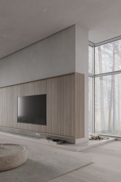 an empty living room with large windows and a flat screen tv on the entertainment center