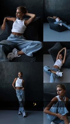 a woman sitting on top of a couch next to a black wall and wearing jeans