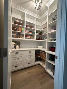 a kitchen with white cabinets and drawers