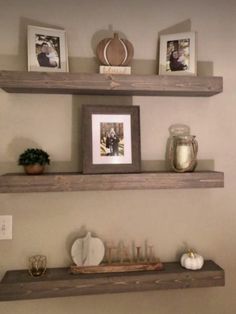 some shelves with pictures and candles on them