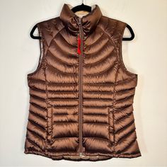 Bernardo Womens Goose Down Puffer Vest Size M Brown Bronze Packable Upgrade Your Winter Wardrobe With This Stylish Bernardo Women's Goose Down Puffer Vest In A Beautiful Shade Of Brown Bronze. The Vest Is Made Of Polyester And Comes In A Regular Size For Women. It Features A Sleeveless Design, Zip Closure, And A Packable Feature Which Makes It Easy To Carry Around. The Exterior Color Of The Vest Is Brown And It Has A Puffer Jacket Style. The Theme Is Metal And It Is Perfect For The Fall And Wint Trendy Vest, Puffer Jacket Style, Puffer Vest, Fall And Winter, Winter Wardrobe, Jacket Style, Puffer Jacket, The Fall, Puffer