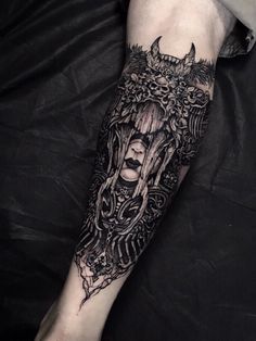 a woman's arm with an intricate tattoo design on the left forearm and hand