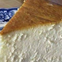 a piece of cheesecake sitting on top of a blue and white plate