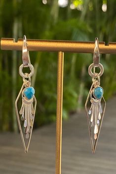 Inspired by the vibrant and serene waters of Key West, these Sterling Silver Earrings showcase stunning turquoise pendants. The fan tassels gracefully sway, mimicking the gentle movement of waves, while adding a playful and bohemian touch to your look. Elegant Turquoise Earrings With Tassels, Elegant Turquoise Jewelry With Tassels, Turquoise Tassel Drop Earrings, Gentle Movement, Pink Tassel Earrings, Pink Wrapping Paper, Key West Fl, Earrings Handmade Dangle, Fan Earrings