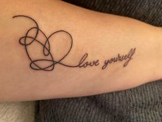 a woman's arm with a tattoo that says love yourself on it and an interlocked heart