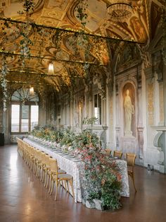 an elaborately decorated dining room with long tables and flowers on the tablecloths