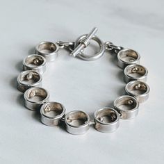 This wonderful chunky round link bracelet is beautifully crafted!  It has a toggle clasp and is marked (and tested) 925.  It is approximately 8 inches long but fits more like 7 1/2 inches.   Weight is 47 g.  In excellent condition--ready to be worn and enjoyed! Note:  Vintage jewelry is jewelry that has been owned and worn previously.  It may have light scratches and/or some tarnish.  I give all my sterling (925) silver pieces a light polish, but leave serious polishing up to the discretion of the buyer. Everyday Silver Bracelet With Toggle Clasp, Everyday Chain Bracelet With Toggle Clasp, Everyday Sterling Silver Bracelet With Toggle Clasp, Modern Sterling Silver Bracelets With Toggle Clasp, Sterling Silver Toggle Clasp Bracelet Gift, Sterling Silver Round Bracelet With Toggle Clasp For Gift, Sterling Silver Bracelet With Toggle Clasp Gift, Sterling Silver Bracelet With Toggle Clasp, Sterling Silver Bracelets With Box Clasp