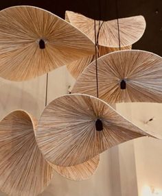 several umbrellas hanging from the ceiling in a room