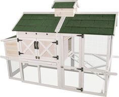 a large white chicken coop with green roof and two doors on each side, attached to a wall