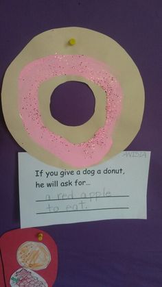 a paper donut with pink sprinkles and a note attached to it