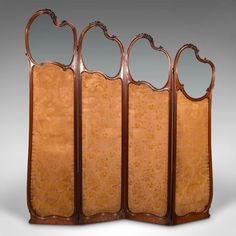 an antique wooden room divider with three mirrors on it's sides and four panels at the top