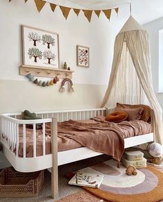 a bedroom with a bed, rugs and pictures hanging on the wall above it