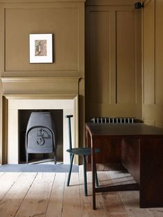 an old fashioned stove is in the corner of a room with wooden floors and walls