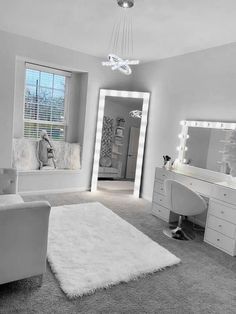 a bedroom with white furniture and large mirrors on the wall, along with an area rug that looks like sheepskin