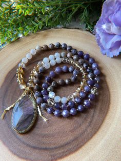 This necklace is 90 beads of Amethyst, Lepidolite, Petrified Fluorite, Citrine, Clear Quartz, and is finished with Brass spacers + a gorgeous flashy purple Labradorite pendant. Created + packed with love + intention! 💫 Mala purchases come with shipping insurance to ensure they arrive safely! 💕 Free US Shipping on $100+ orders. Shipped in 2-5 business days from Florida. 🌞🌴 Every order helps a kitten! 🐱 2023 The Crystalline Moon Dainty Chain Necklace, Hand Knotted Necklace, Magic Hands, Crescent Moon Pendant, Practical Magic, Orders Shipped, Purple Labradorite, Knot Necklace, Labradorite Pendant