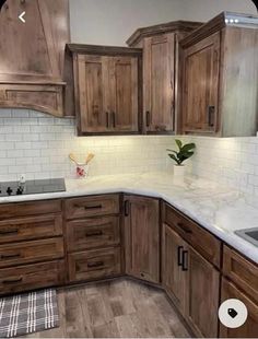 a kitchen with wooden cabinets and white counter tops