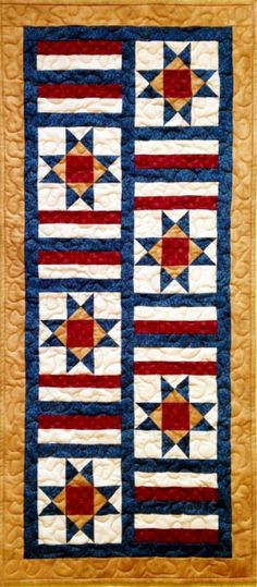 a quilted wall hanging on the side of a wooden frame with an american flag design