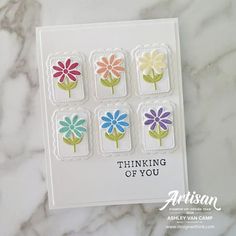 a card with four flowers on it and the words thinking of you written in white