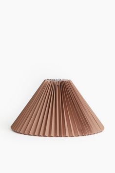 a brown pleated lamp shade on a white background